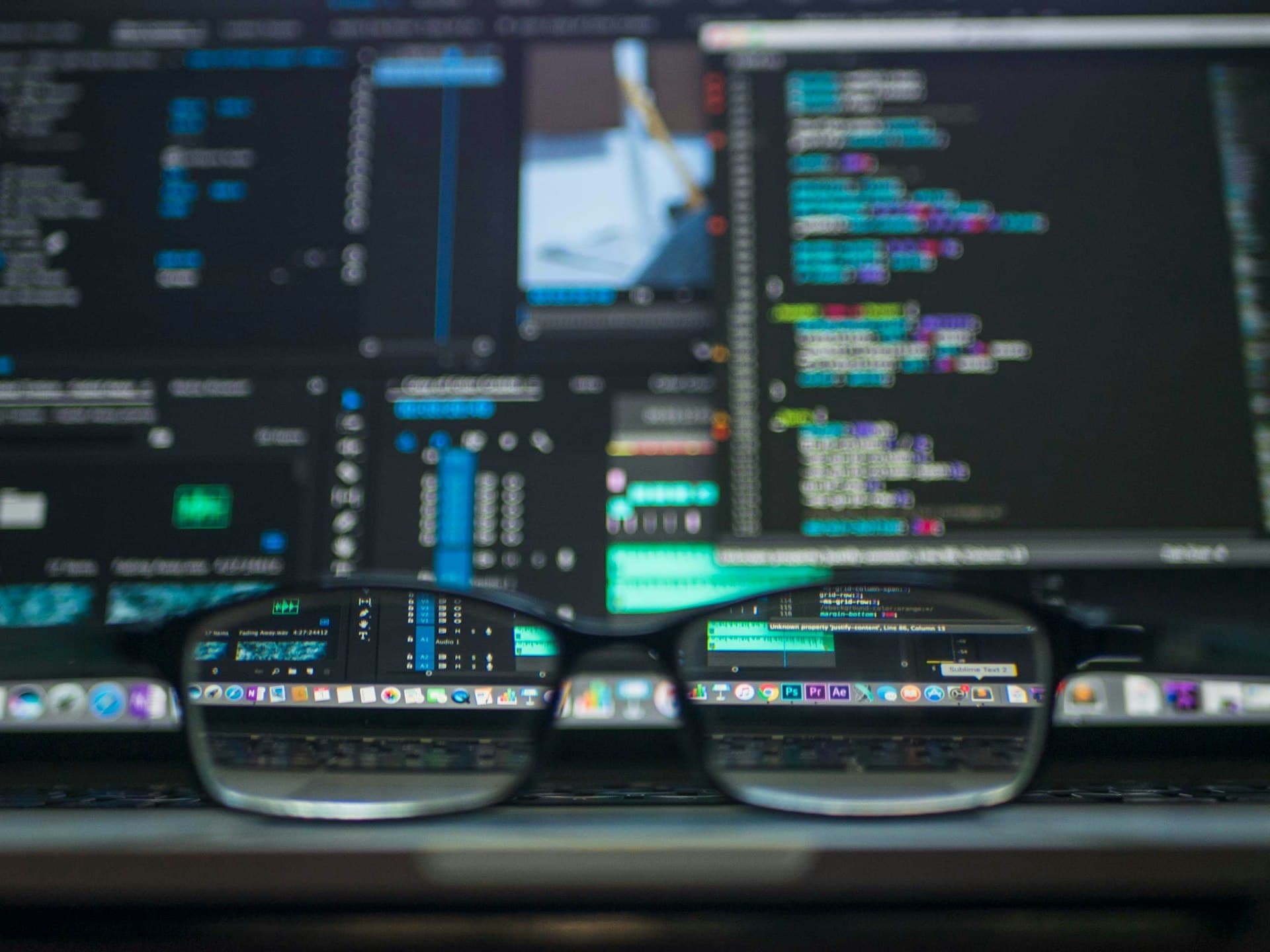 Developer working on a laptop with code on screen