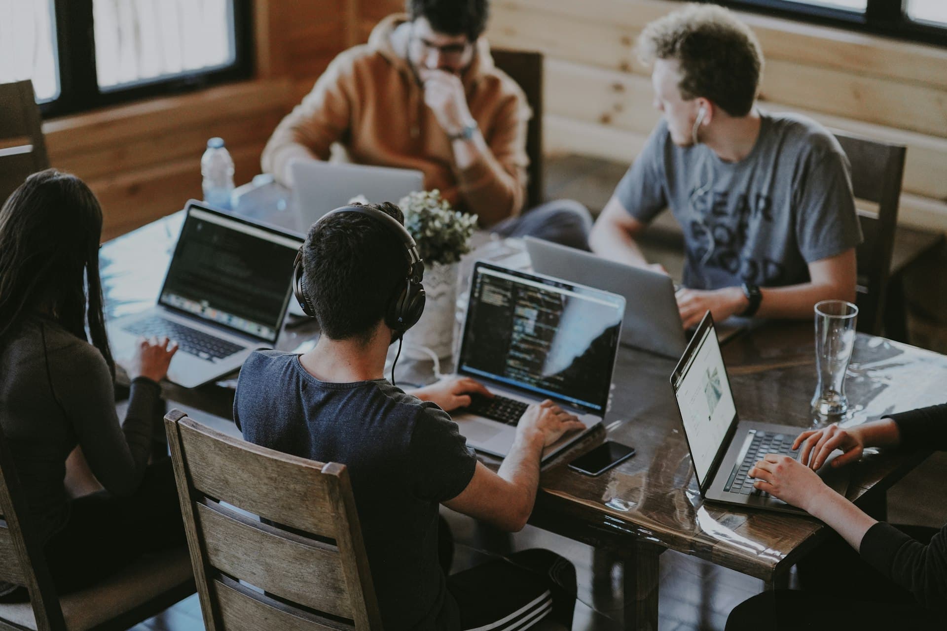 Team collaborating at computers in a modern workspace
